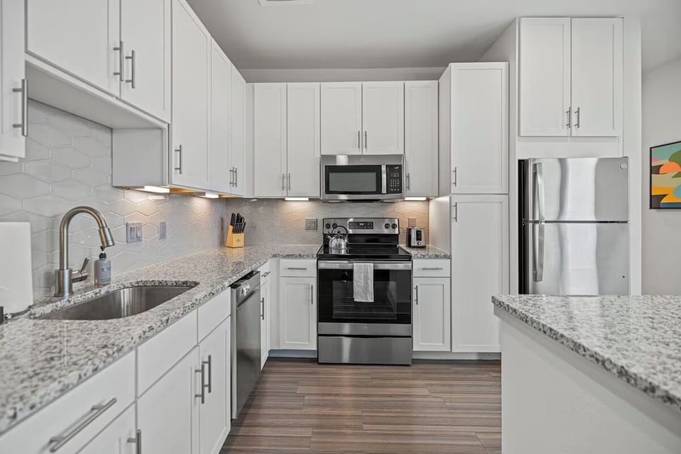 Cook with ease in a spotless, full kitchen setup.