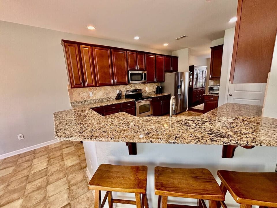Spacious kitchen with bar seating.