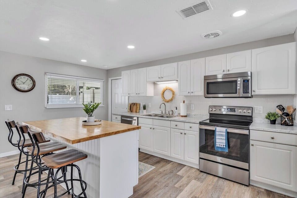 Sleek and functional, the modern kitchen boasts top-tier appliances, a myriad of utensils, and a chic island with three seats, inviting culinary adventures in a stylish, efficient space.