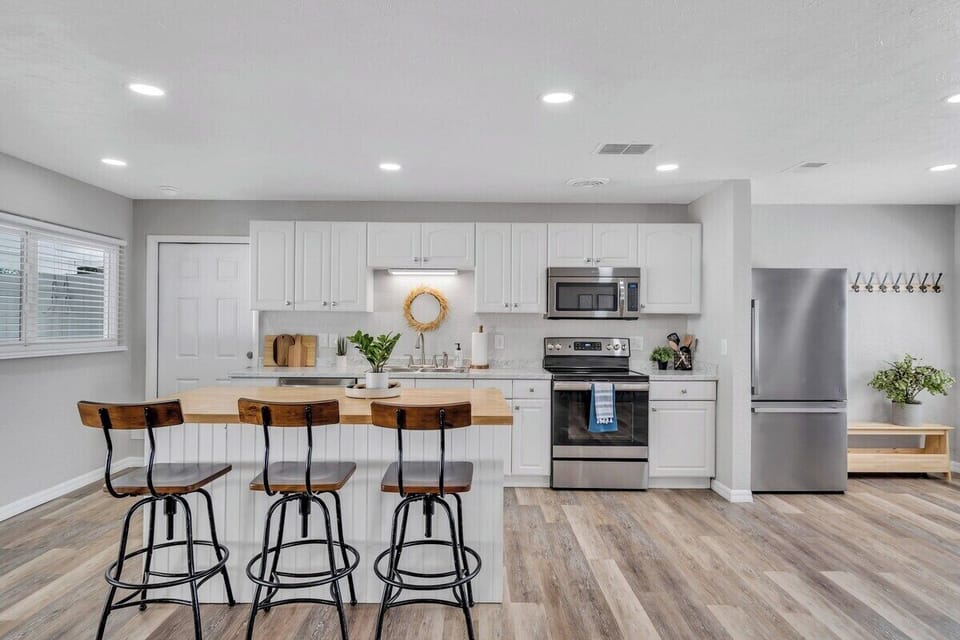Expansive and bright, this kitchen has abundant cabinet space, ensuring seamless organization. The entire space is filled with generous lighting, its open design offers a spacious, inviting culinary haven.