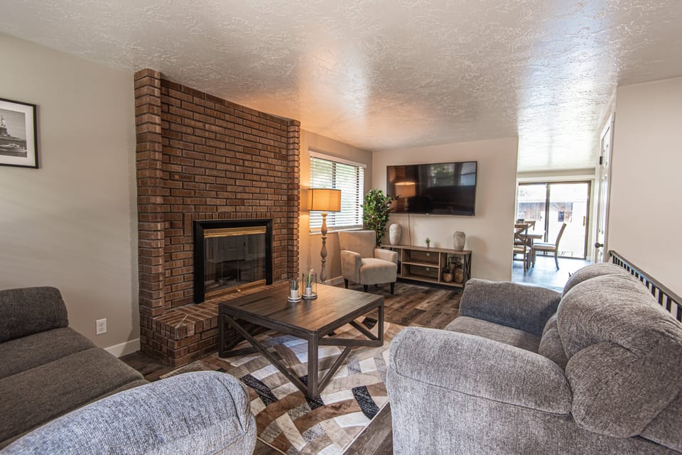 Relaxing living space with fireplace, smart TV, and comfortable seating ideal for movie nights.