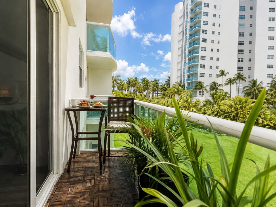 Private balcony with seating and tropical plants for a relaxing outdoor space