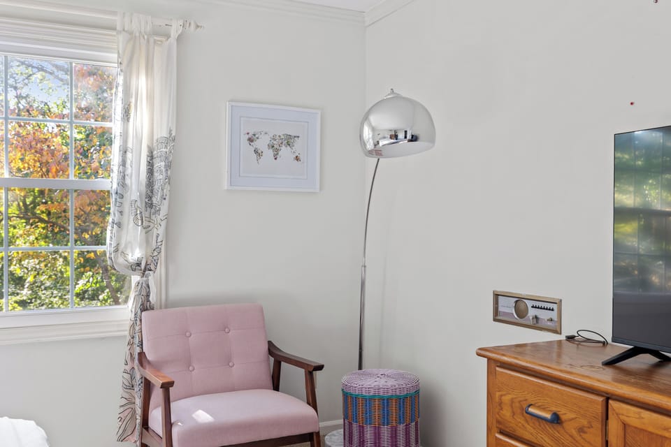Willow on the Pond - Chair and smart tv in the master bedroom. 
