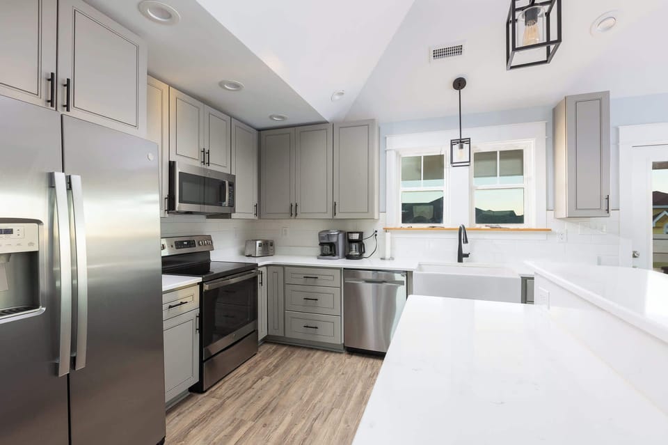 Top Level: Fully equipped kitchen featuring GE stainless steel appliances, granite countertops, and both Keurig and drip coffee makers.