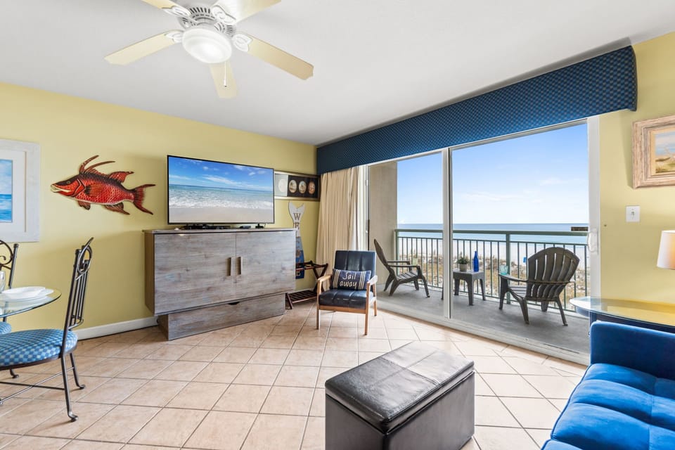 Living Room - Enjoy this living room decorated with pops of colors, tile flooring & a great view!