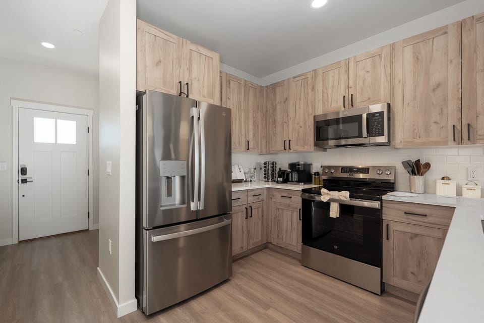 Cook your favorite meals in this bright, modern kitchen featuring stainless steel appliances and ample counter space for all your culinary adventures.