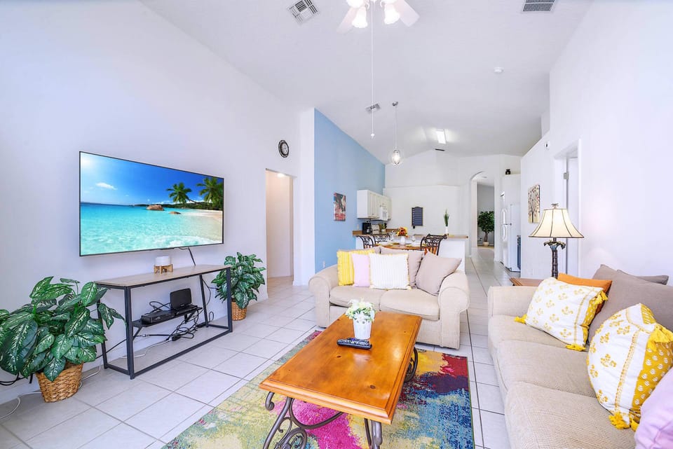 Comfortable Family Room with a Smart TV and Pool View