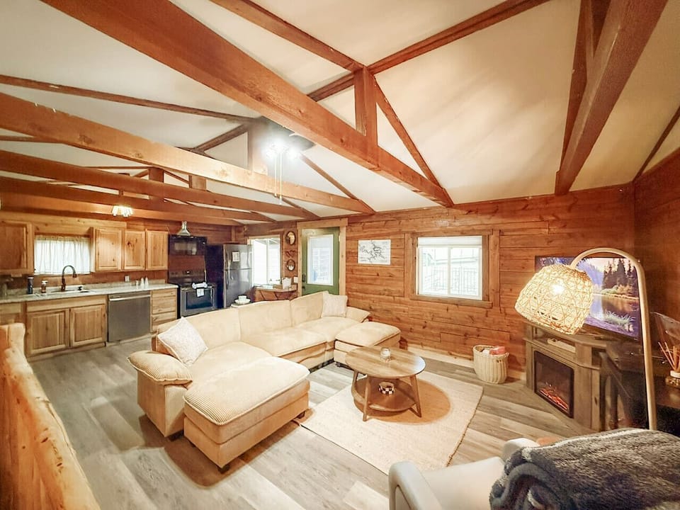 Inviting sectional sofa, cozy fireplace, and rustic charm throughout.