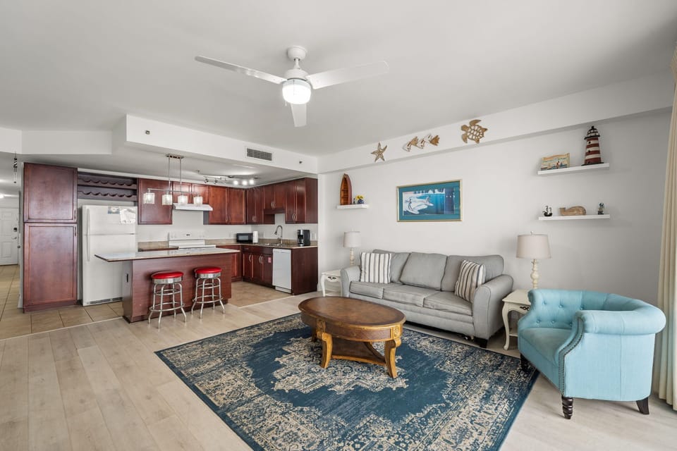 Open-concept living area with a coastal-inspired design and fully equipped kitchen.