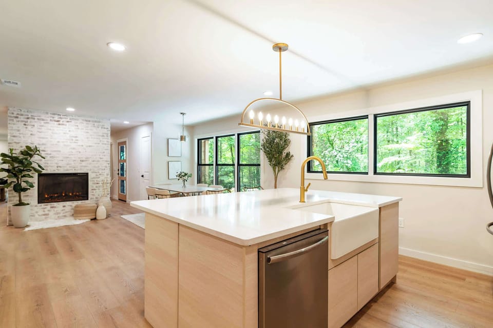 Open-concept living with forest-facing windows and inviting gathering spaces