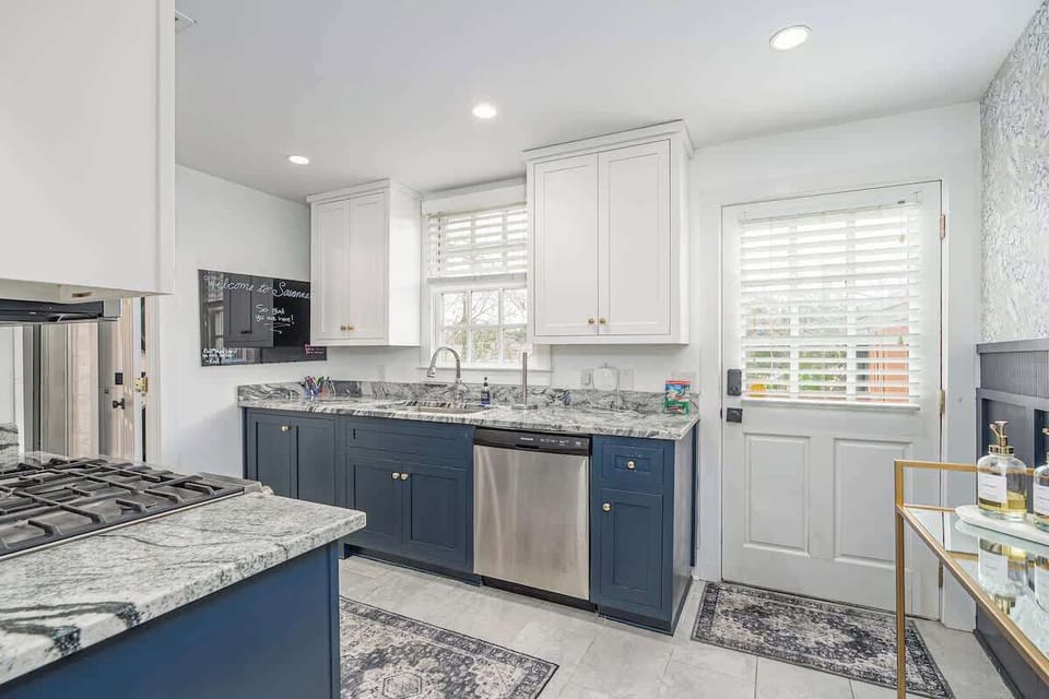 A small kitchen with big personality. Blue accents and white cabinetry create a bright, inviting space for light bites or lazy mornings.