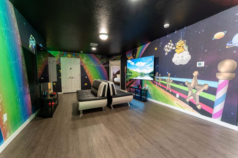 Race into fun in our vibrant Mario Kart-themed game room, featuring a large TV and comfy seating