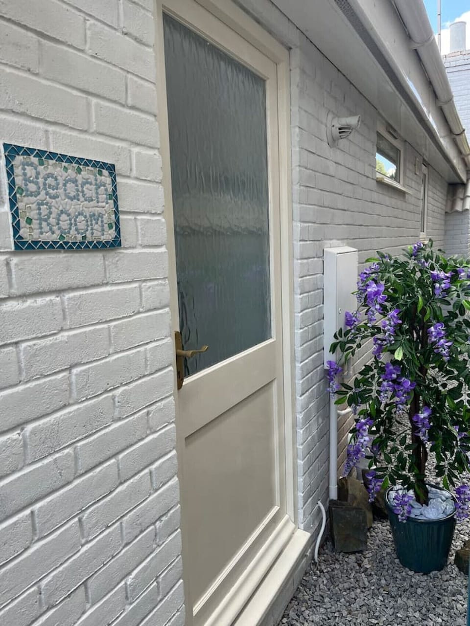 Private entrance by the lilac bush