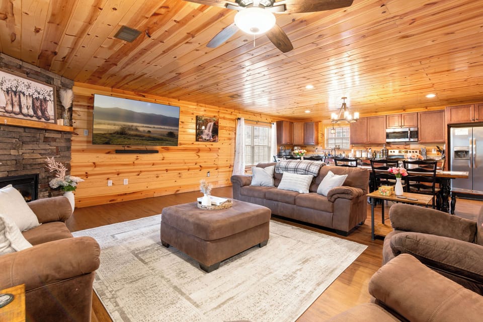 Cozy cabin great room with fireplace, big TV & modern kitchen