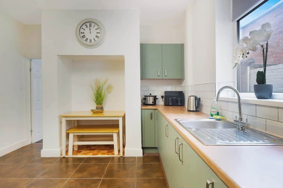 Kitchen equipped with all essentials, including an oven, fridge, and full cookware set.