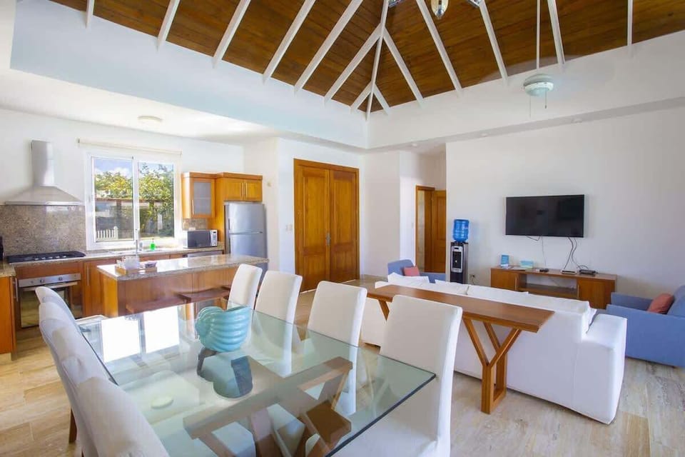 Open-concept dining room with high ceilings and a seamless flow to the kitchen and living area.
