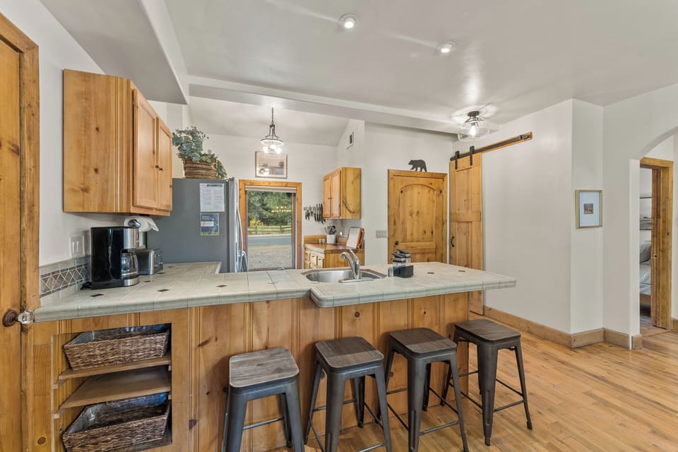 Our fully equipped kitchen is a culinary Delight with a drip coffee maker, dishwasher, breakfast bar and more! 
