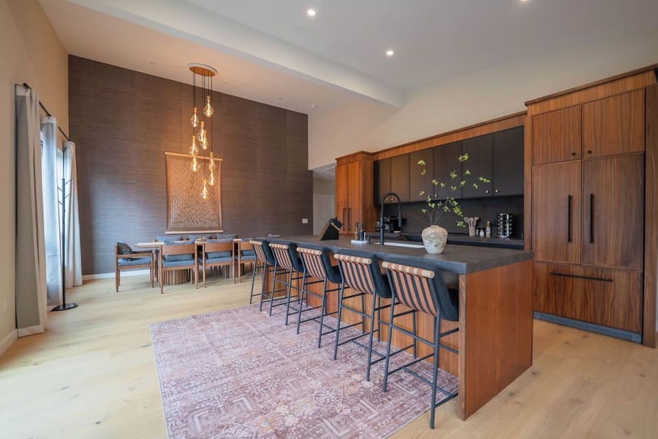 Custom kitchen with high-end Fisher Paykel appliances and generous counter space — fully equipped for cooking for a crowd.