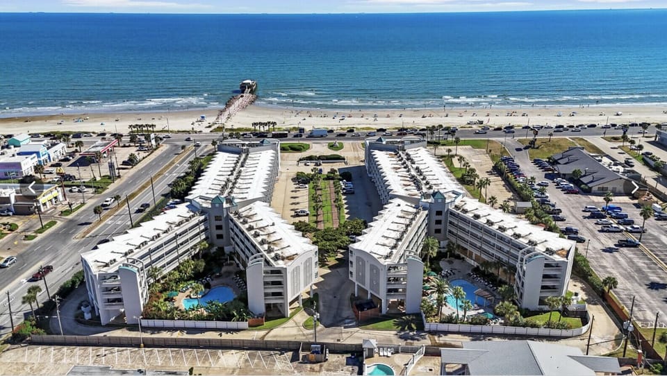 Aerial view of Casa del Mar Beachfront Suites—spacious resort living in the heart of Galveston, steps from the sand and local attractions.