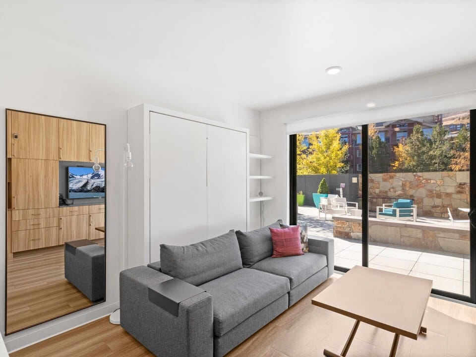 Studio living area with queen Murphy bed and balcony