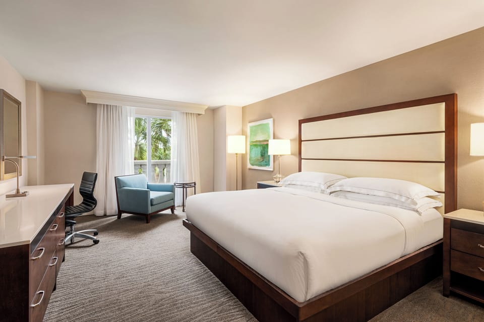 Unwind in a sunlit king room with calming views.