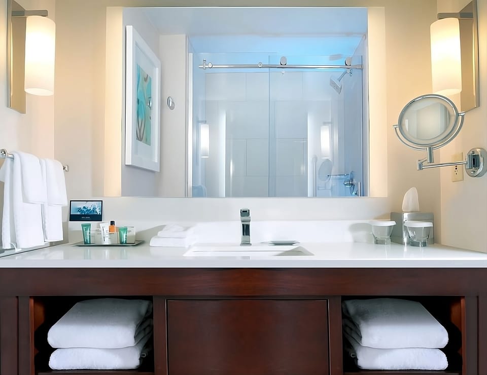 Refresh effortlessly with bright lighting and neatly stocked linens.