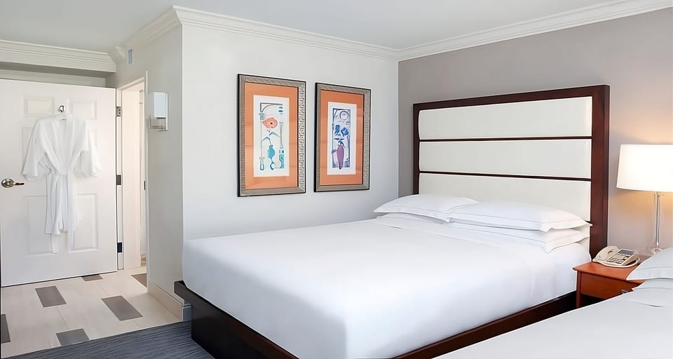 Drift off in cloud-soft bedding under warm bedside lighting.