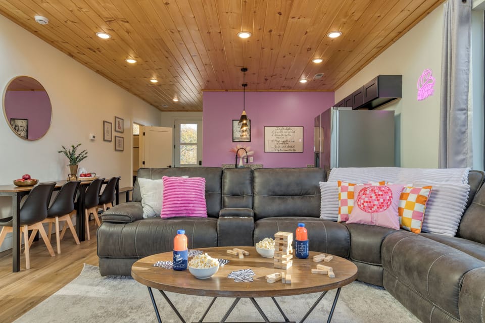 Gather in this airy open layout featuring a chic kitchen, cozy seating, and floor-to-ceiling natural light.