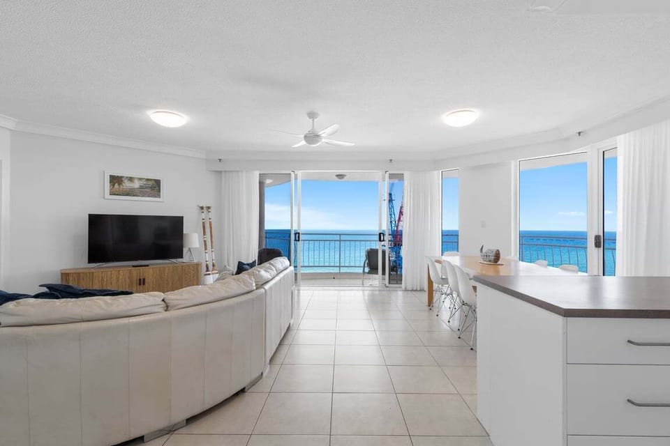 Spacious open-plan living with panoramic ocean view backdrop
