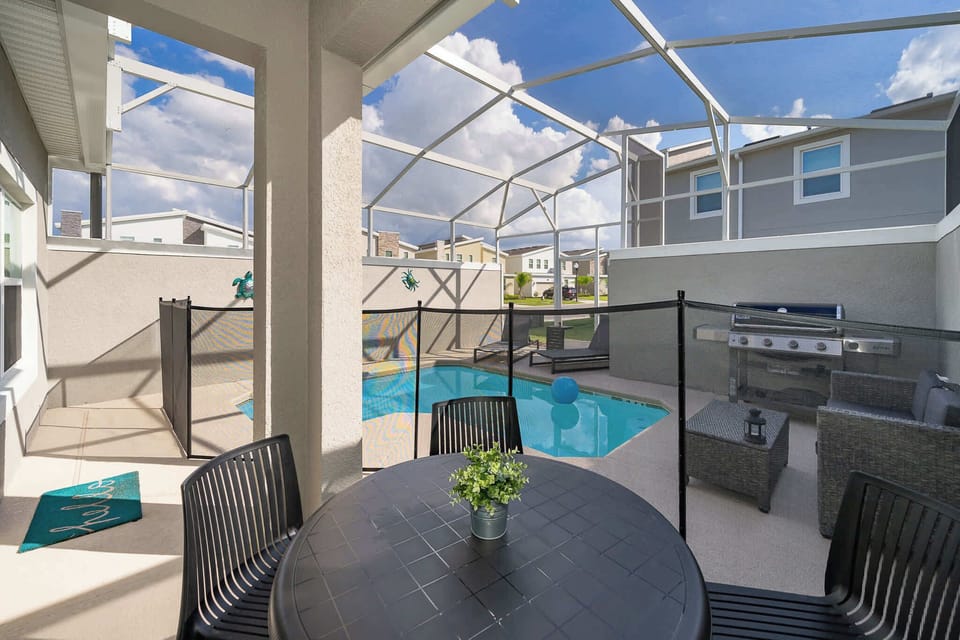 Enjoy a private screened patio with a pool and outdoor grill for relaxing gatherings.