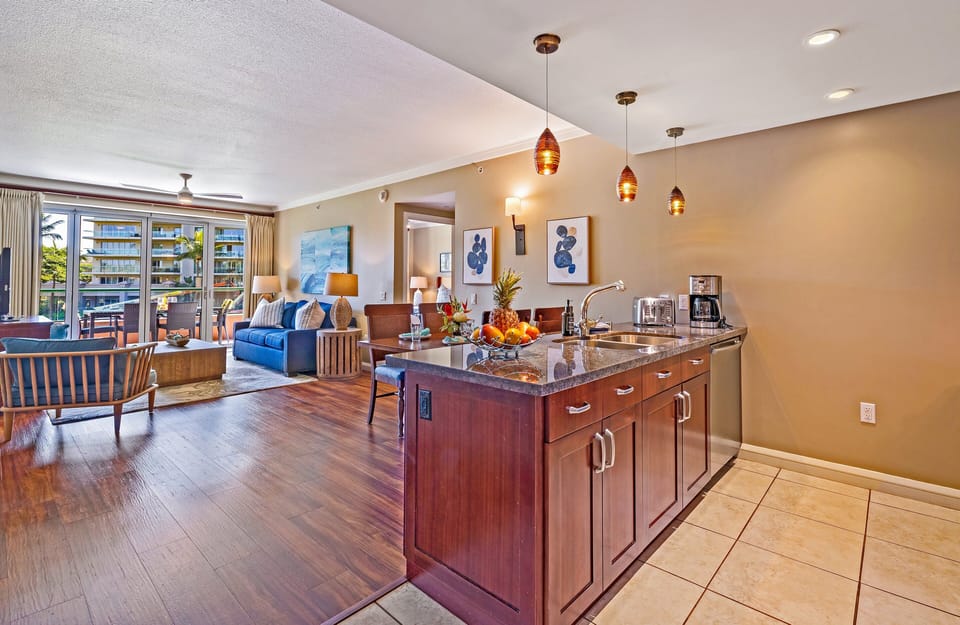 Relax in a bright, airy living and dining area with warm wood tones, stylish décor, and easy access to the kitchen.