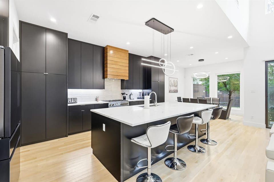 Designed with sleek cabinets and modern fixtures, this fully equipped kitchen offers the best of functionality and luxury with a center kitchen island and mini bar!