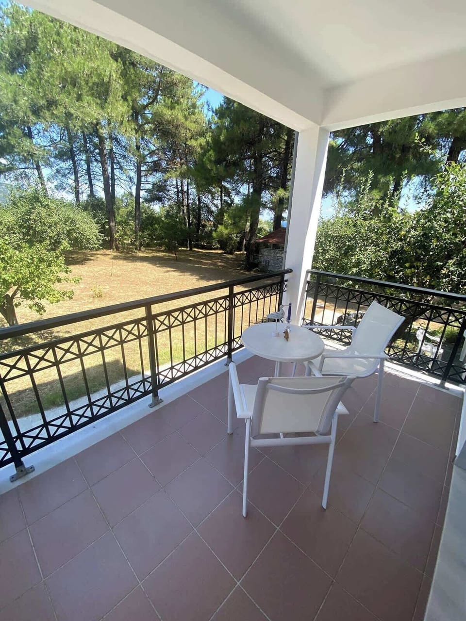 Covered terrace with seating  — perfect for dining outdoors with a coastal breeze.
