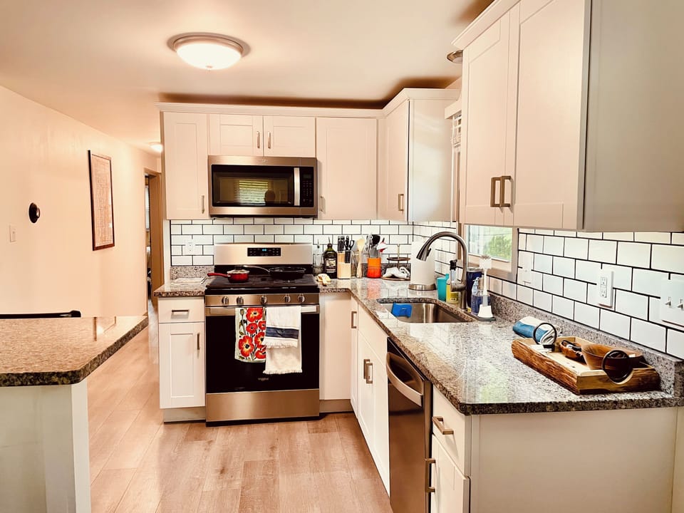 Fully stocked kitchen, stove, microwave, dishwasher.