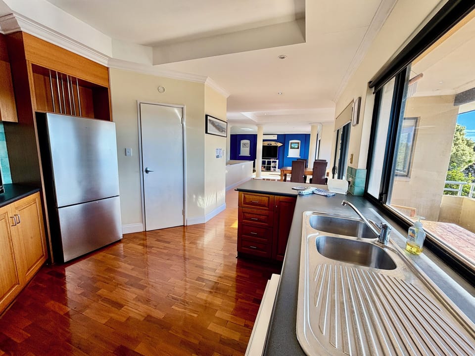 Kitchen with a full size large fridge with freezer, dishwasher, pantry, west facing windows 