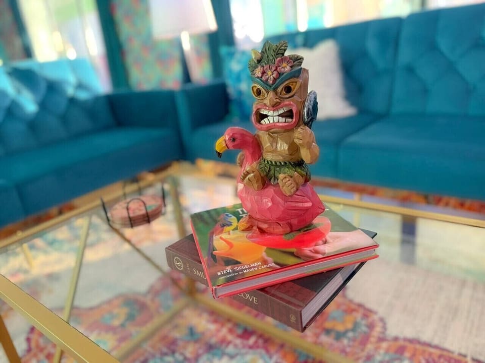 A whimsical tiki statue centerpiece adds a fun, tropical touch to the living space.