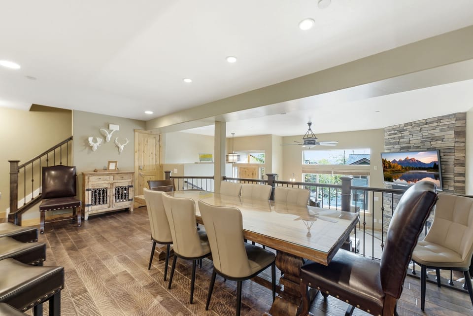 Gather the whole group around the expansive dining table overlooking the main living room.