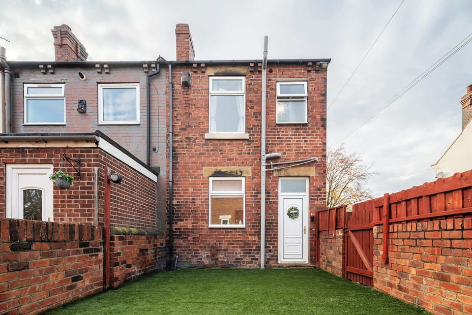 Brick house exterior with easy access and private outdoor space.