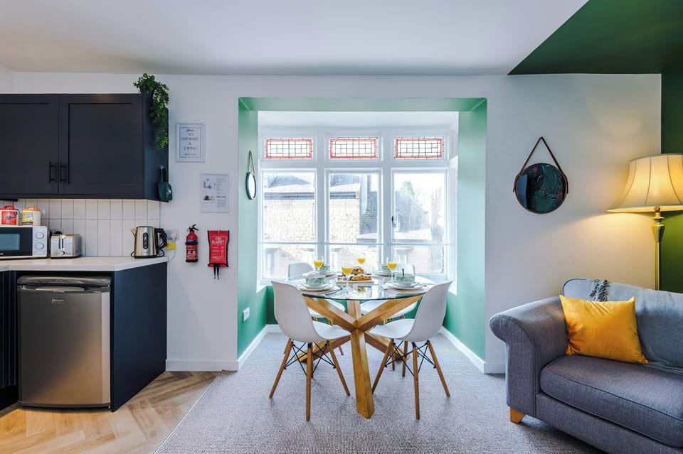 Bright dining area with large windows overlooking charming Buxton streets.