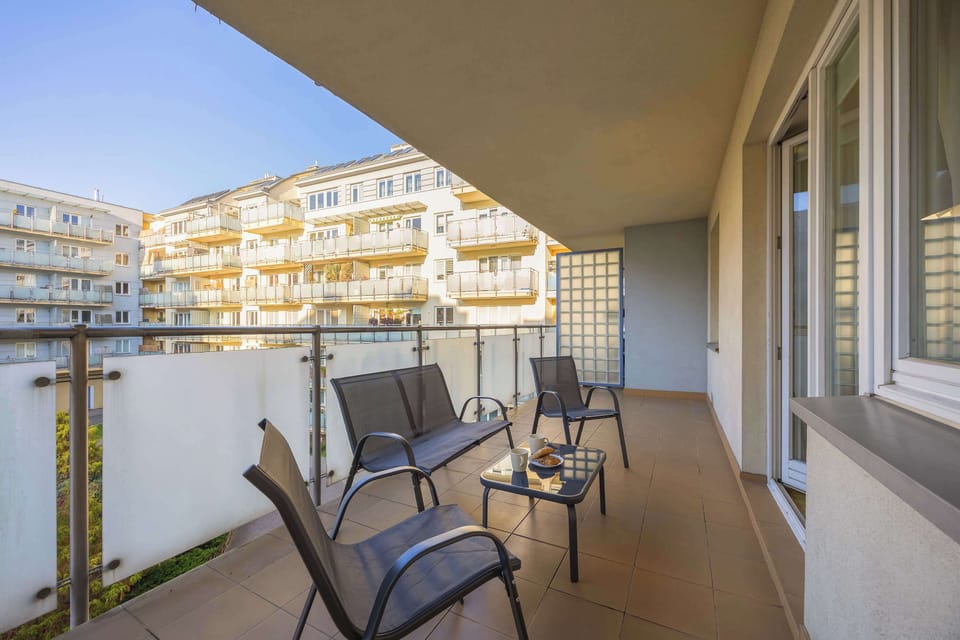 Another angle of the balcony showing the railing and seating area. The scene feels peaceful and relaxing.