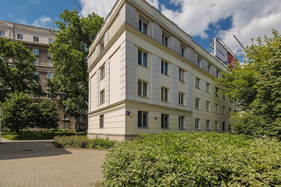 The building is modern, well-maintained, and surrounded by a quiet, green courtyard.