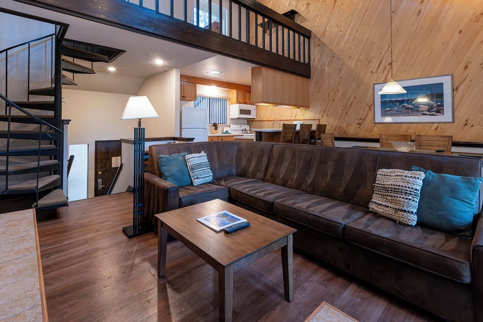 Unwind on the cozy sectional beneath soaring chalet-style ceilings.
