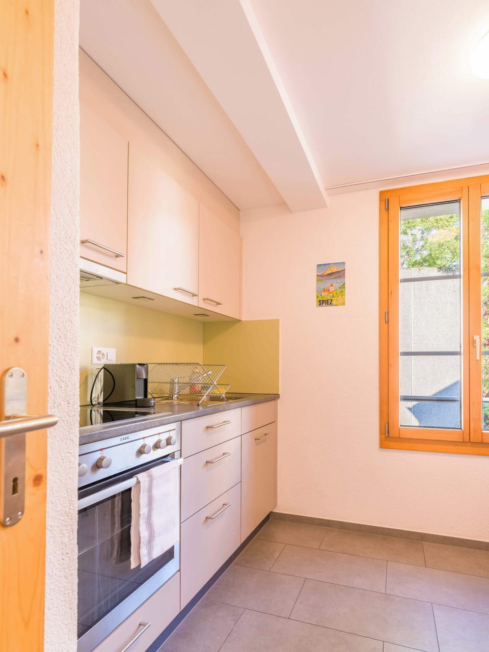 Bright kitchen with modern appliances and window view
