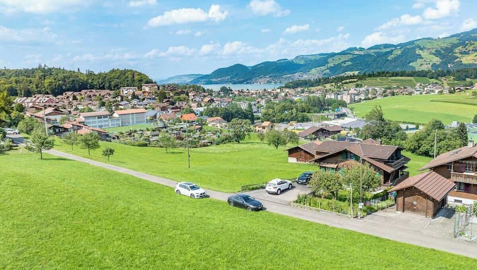 Chalet exterior surrounded by green meadows
