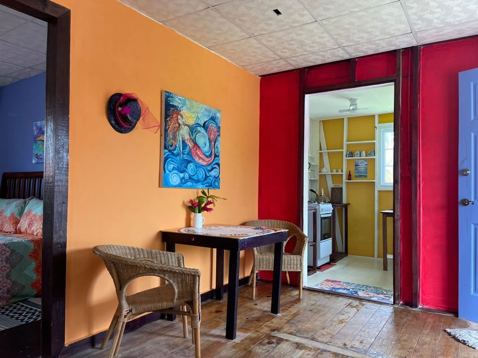 Dining area located between living room, kitchen and bedroom.