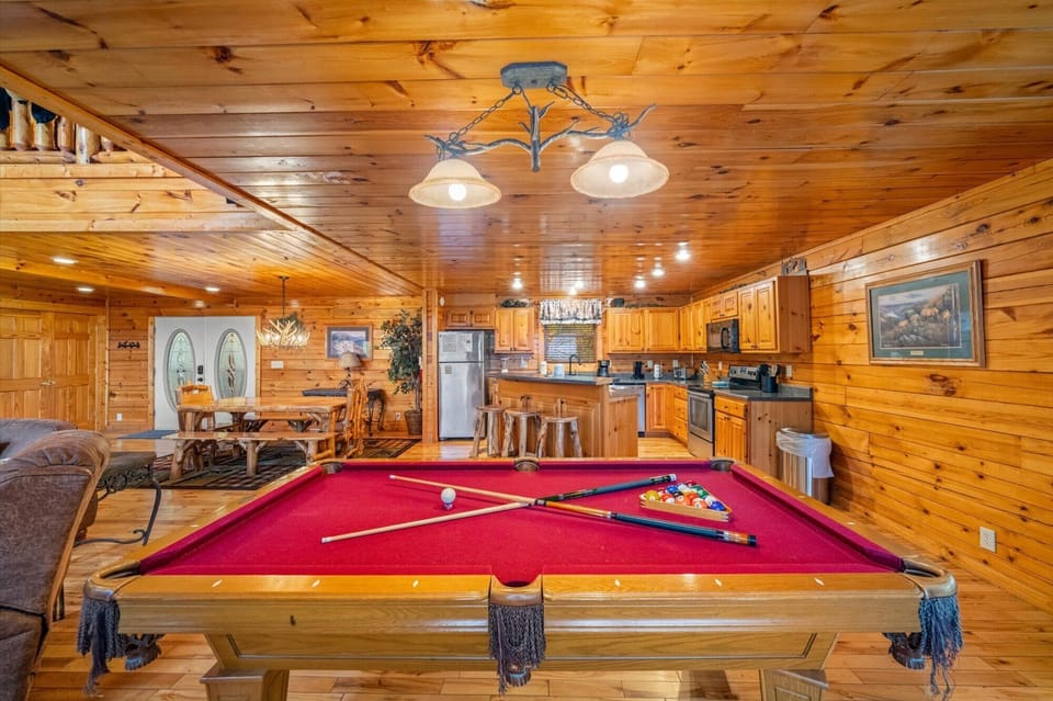 Play a game of pool w/ access to bar top and big screen tv in the living room.
