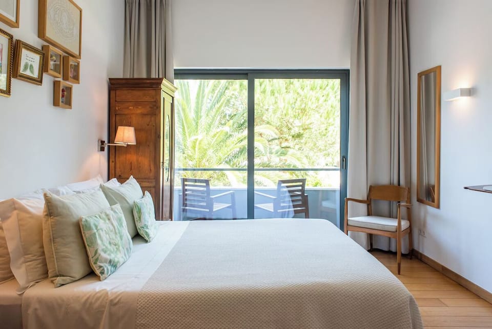 Unwind in crisp linens with a sunlit balcony view.