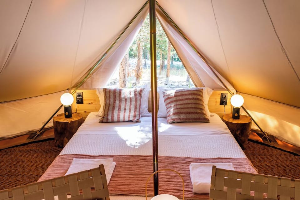 Sink into crisp linens as forest views greet you.