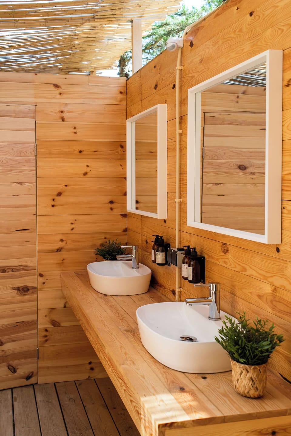 Refresh at twin basins in a sunlit wooden bath.