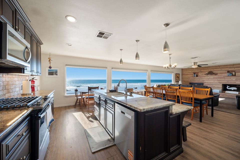 The open concept living areas with wall to wall windows showcase the endless views